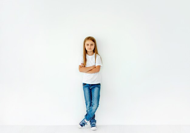 Cute little girl with crossed hands isolated on white