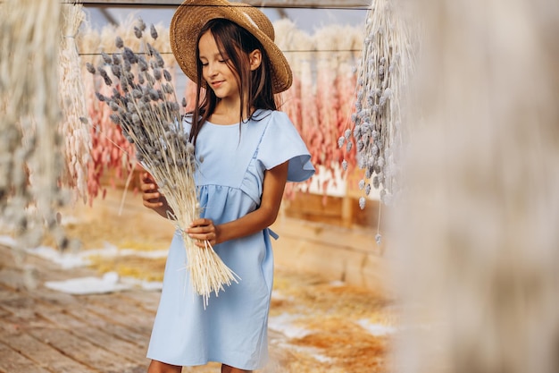 Фото Милая маленькая девочка с декоративными сушеными кукурузными початками