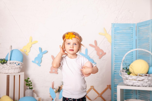 Cute little girl with Easter eggs Easter interior Spring decor Easter concept Portrait of child with Easter decorations