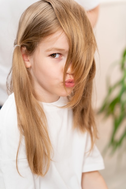 Cute little girl with funny collected hair