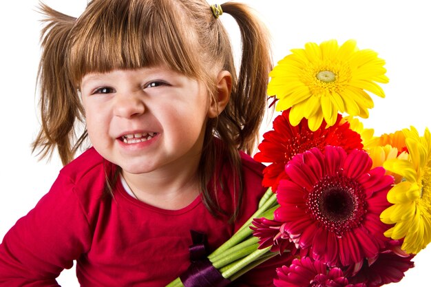 Cute little girl with gerbera flowers bouquet