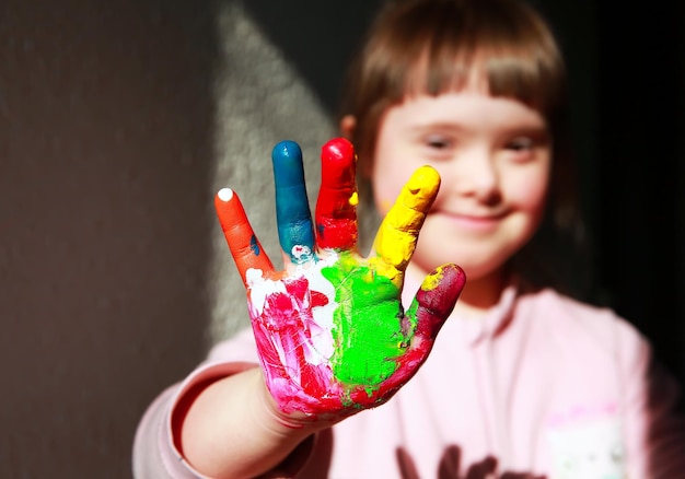 Cute little girl with painted hands