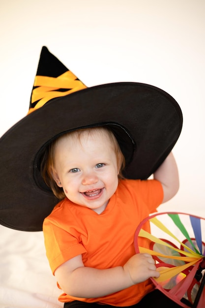 Cute little girl with red hair in a witch39s hat on Halloween Costumes Emotions Holiday