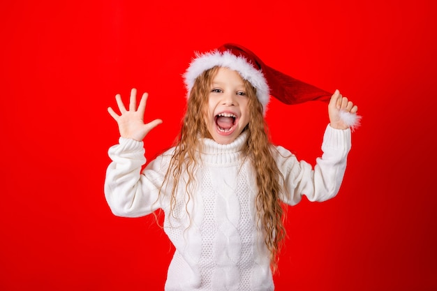 Cute little girl with Santa's hat and a sweater