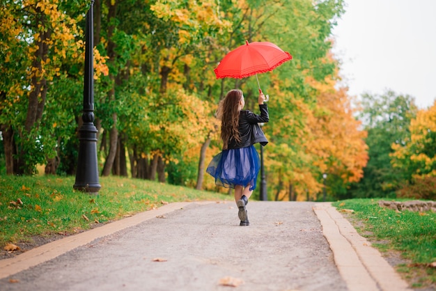 Cute little girl with umbrella. Weather forecast conception