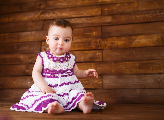 Cute little girl on a wooden floor.