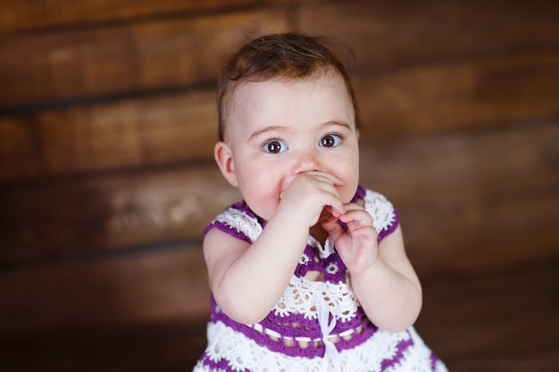 Cute little girl on a wooden floor.