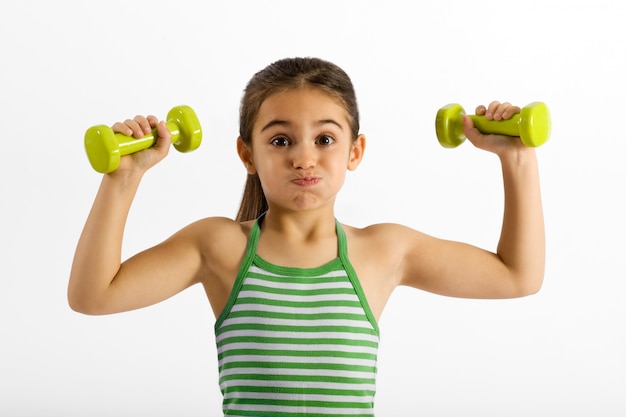 Cute little girl working out with dumbbells