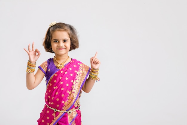 Cute little indian/asian girl showing direction