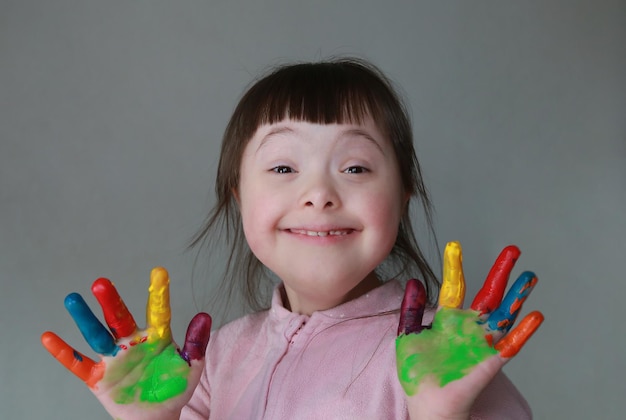 Cute little kid with painted hands Isolated on grey background