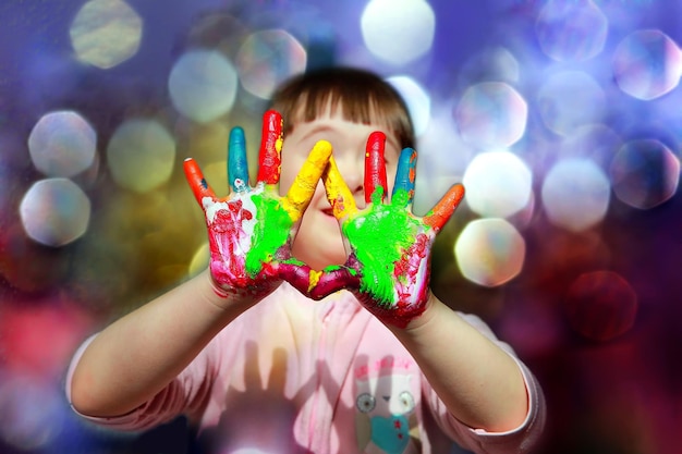 Cute little kid with painted hands.