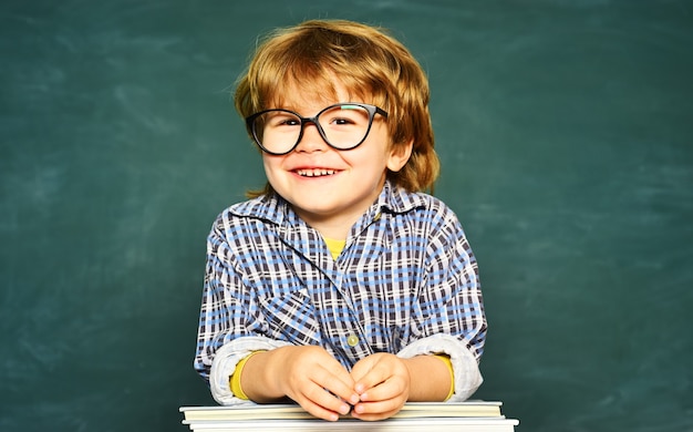 Cute little preschool kid boy in a classroom