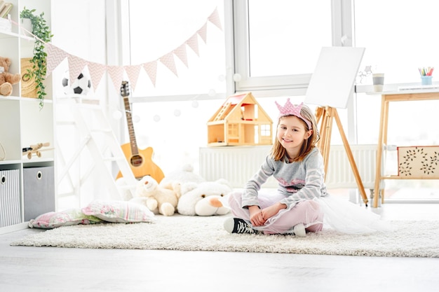 Cute little princess sitting in childrens room