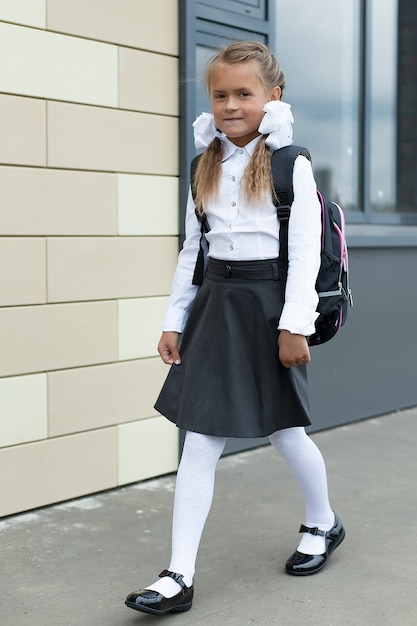 Cute little schoolgirl in her uniform