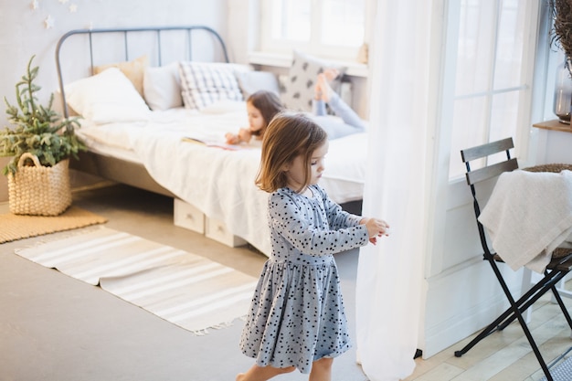 Cute little sisters in their room