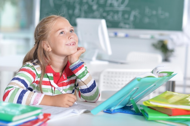 Cute little smiling girl in the classroom