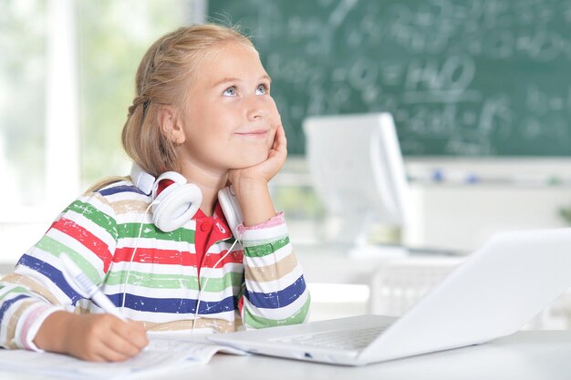 Cute little smiling girl in the classroom