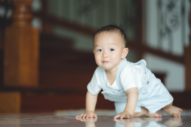 Cute little toddler trying and learning to crawl at home