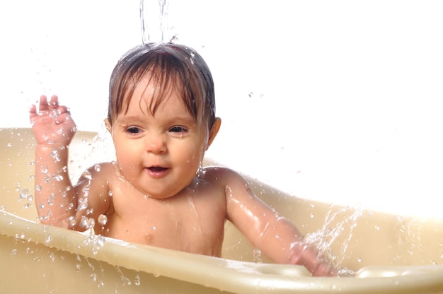 Cute little wet baby girl portrait taking the bath