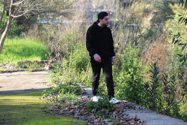 A cute little young boy walking in the outdoor forest park