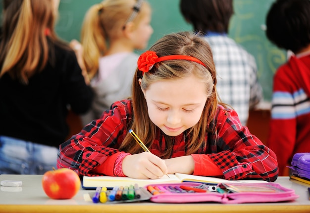 Cute lovely school children at classroom having education activities