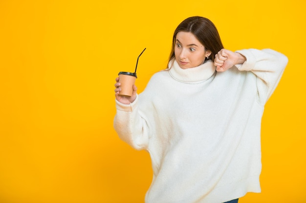 Cute lovely young woman over yellow background