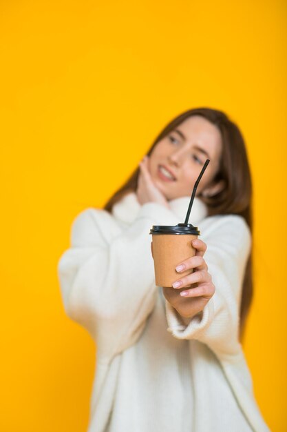 Cute lovely young woman over yellow background