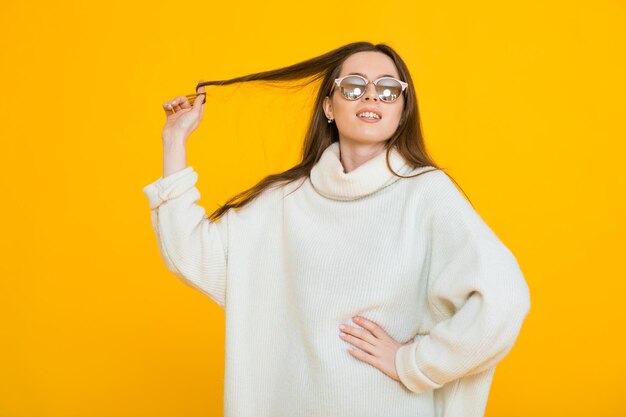 Cute lovely young woman over yellow background