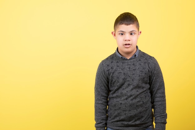 cute male kid in casual clothes standing and looking.