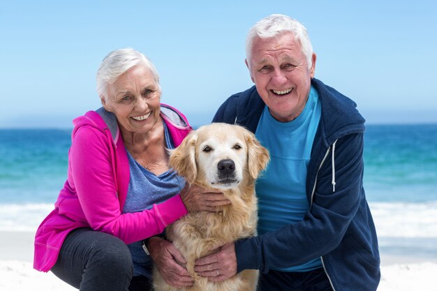 Cute mature couple petting their dog