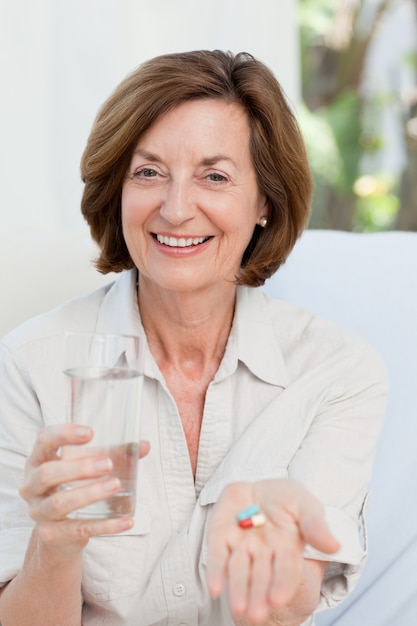 Cute mature woman with pills