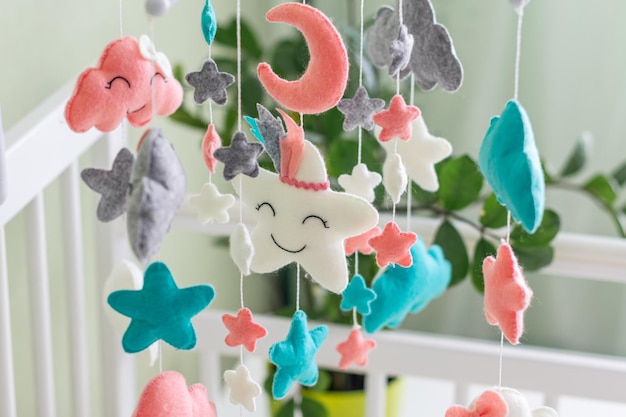 Photo cute mobile with clouds stars and moon hanging on a crib in a children's room