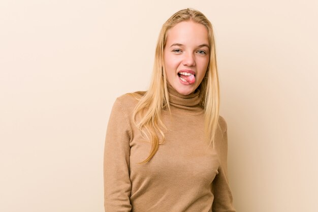 Cute and natural teenager woman funny and friendly sticking out tongue.