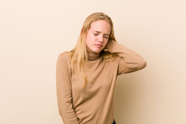 Cute and natural teenager woman suffering neck pain due to sedentary lifestyle.