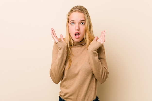 Cute and natural teenager woman surprised and shocked.