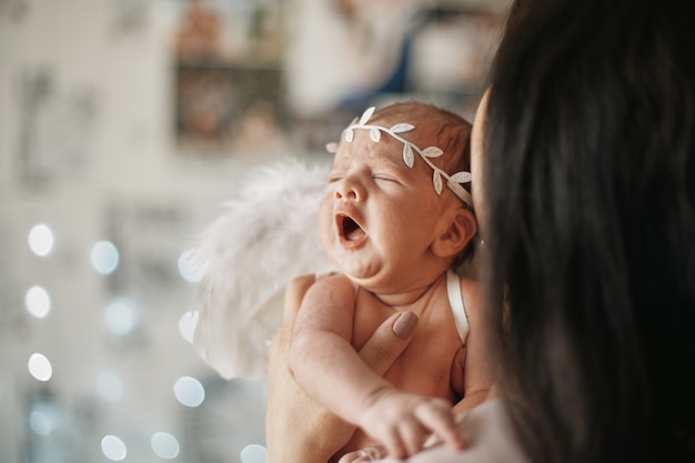 Cute newborn baby in the hands of his mother