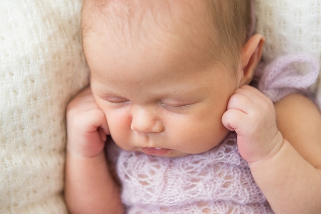 A cute newborn baby is sleeping. Close-up, selective focus