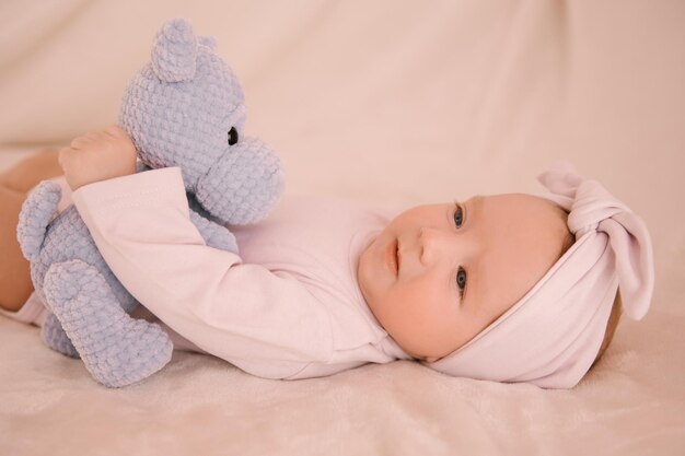 Cute newborn smiling girl on a light background