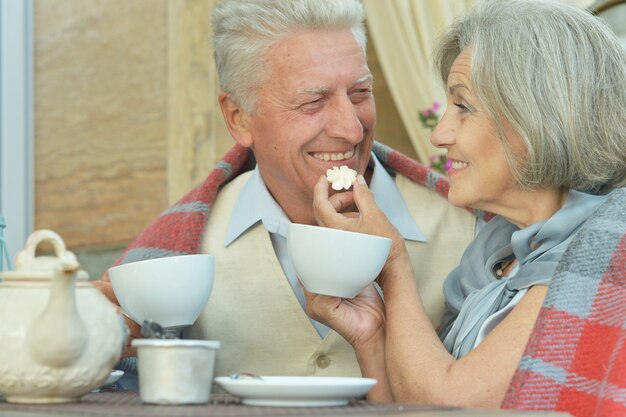 Cute old couple drinking tea together closeup