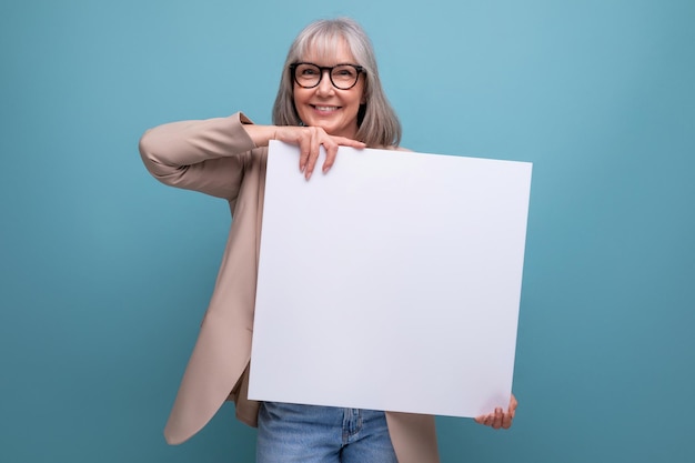 Cute old woman in a jacket with a mocap poster on a bright background with copy space