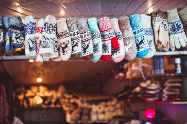 Cute pairs of woolen knitted gloves arranged in a row