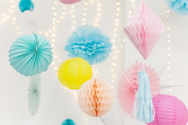 Premium Photo | Cute party paper decorations hanging from the ceiling