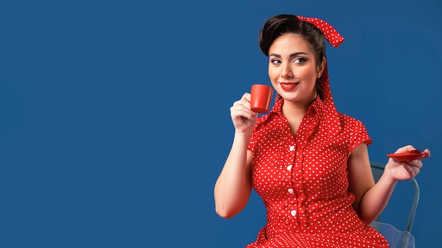 Photo cute pinup girl posing in a blue studio