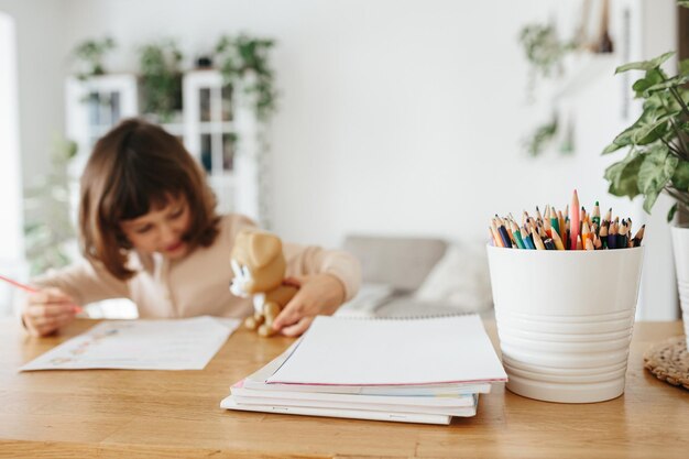 Photo cute preschooler girl learning home homeschooling distance learning for kids