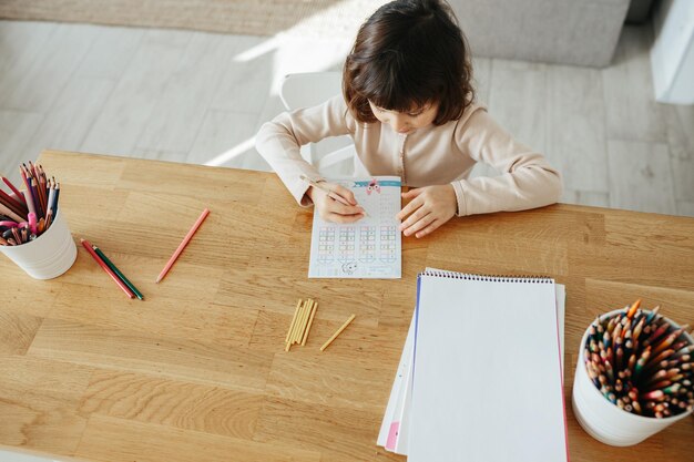 Cute preschooler girl learning home Homeschooling distance learning for kids