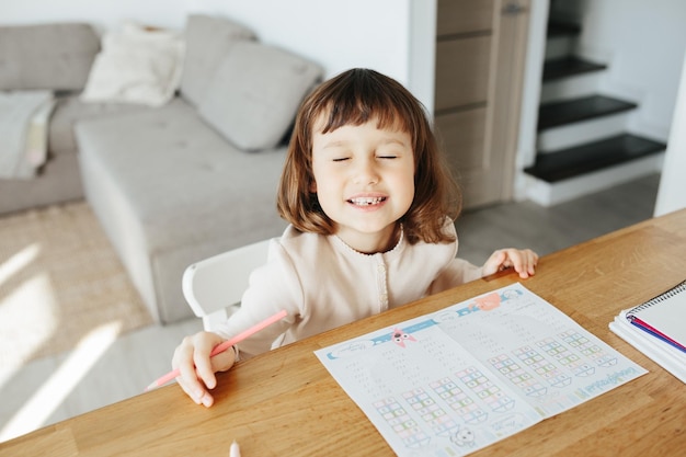 Cute preschooler girl learning home Homeschooling distance learning for kids