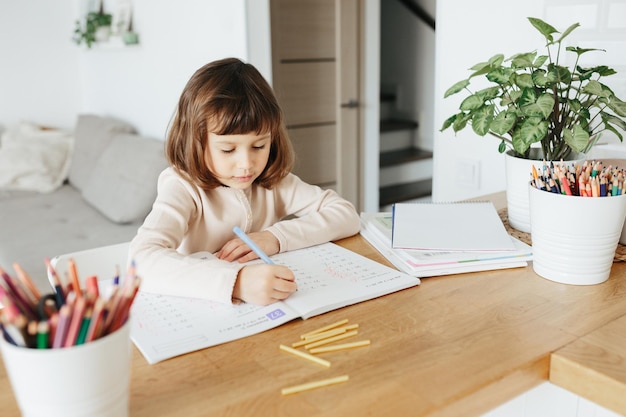 Cute preschooler girl learning home Homeschooling distance learning for kids