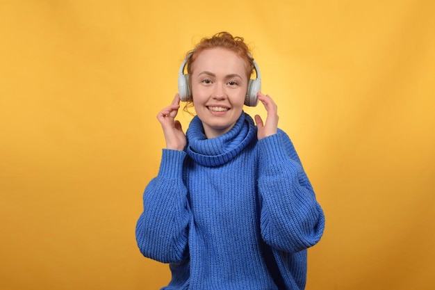 cute pretty woman enjoying music in headphones