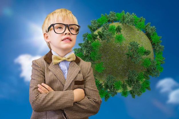 Cute pupil dressed up as teacher against bright blue sky with clouds with globe