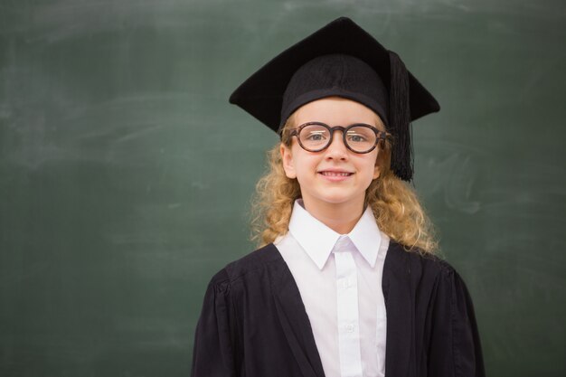 Cute pupil in graduation robe  